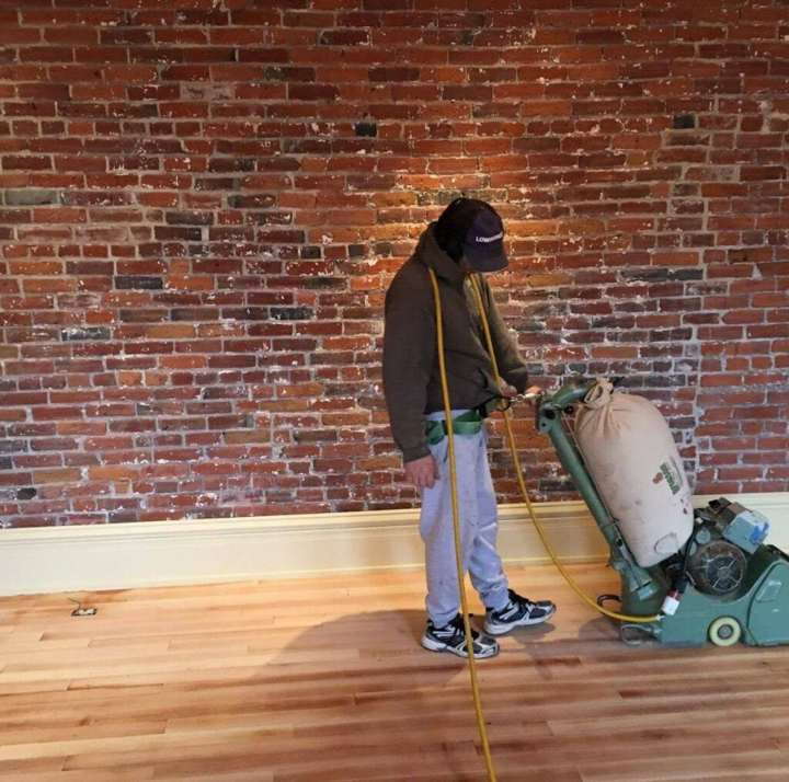 Andy Shoop of Northwest Hardwood Flooring refinishing a hardwood floor